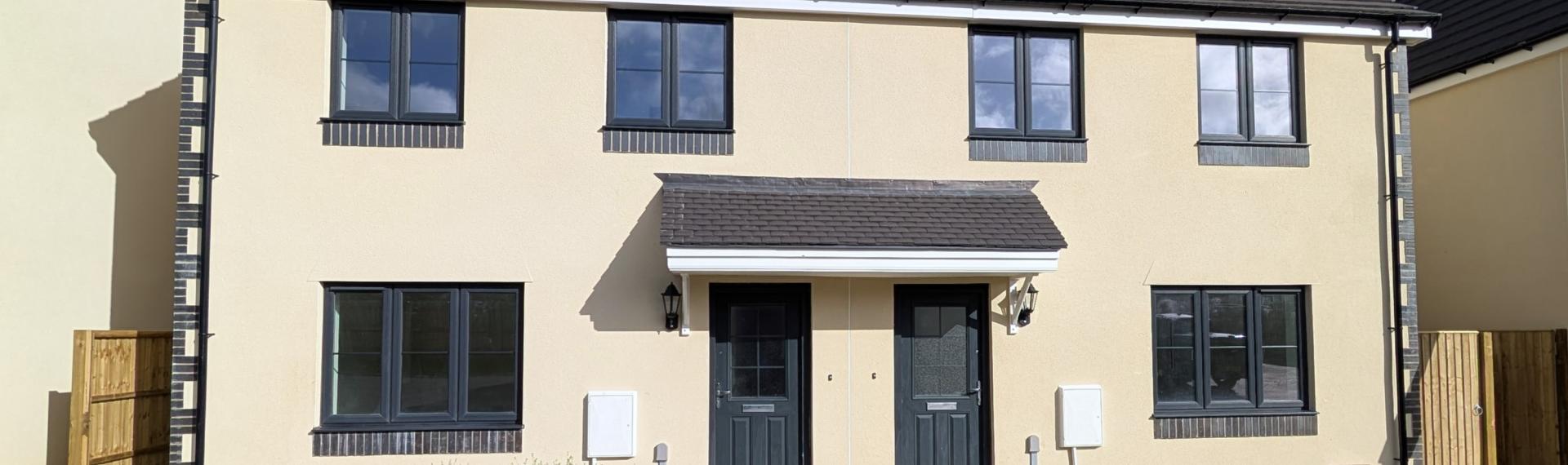 A photograph of 2 semi detached new build homes