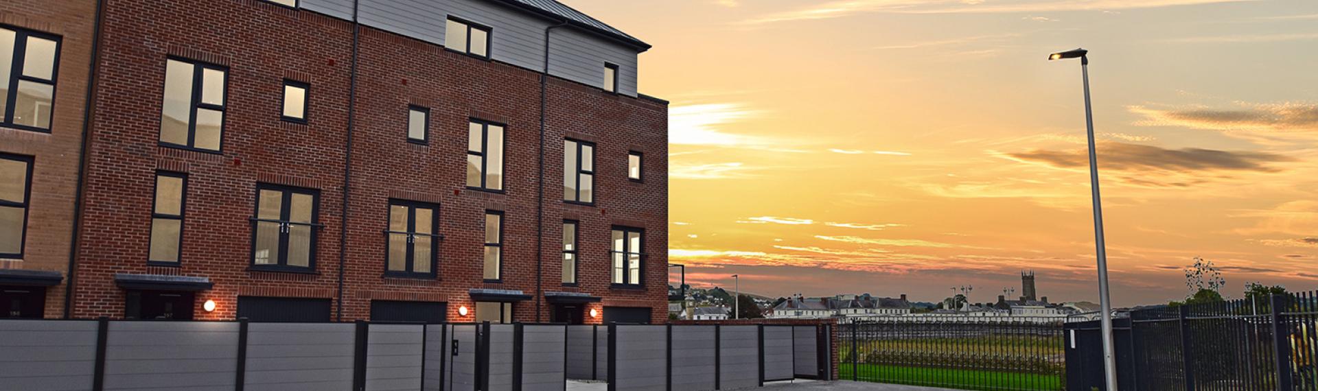 Three terraced townhouses at sunset