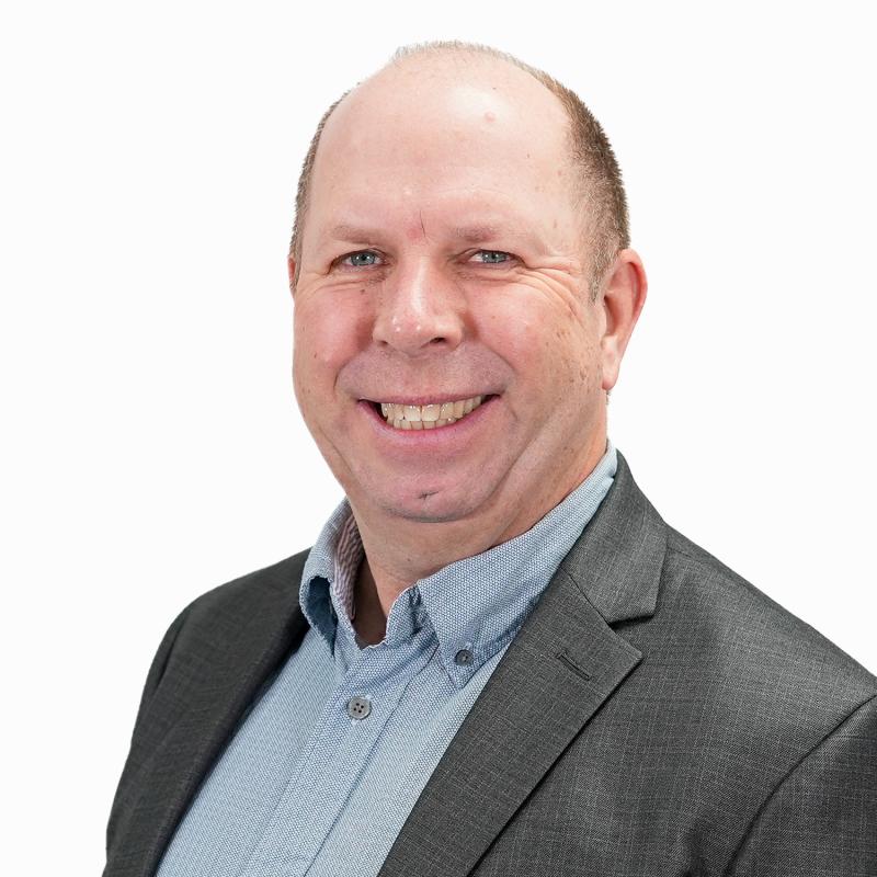 Martyn Gimber; Chief Executive; smiling man wearing a jacket and blue shirt