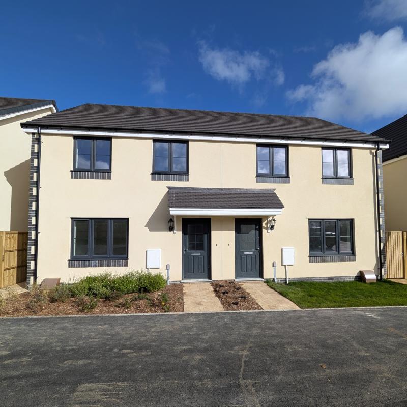 A photograph of 2 semi detached new build homes