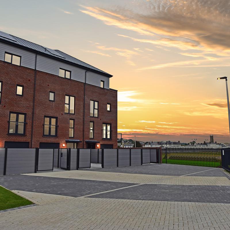 Three terraced townhouses at sunset