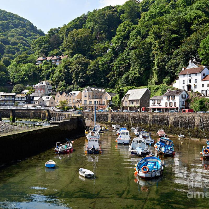 Lynmouth harbour at low tide with boats on the water