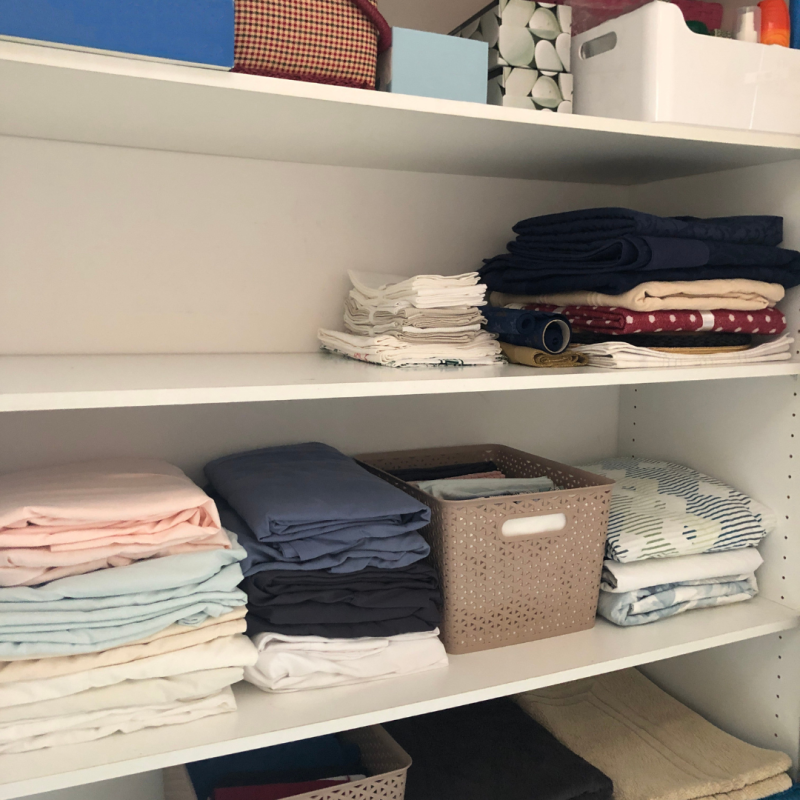 A set of shelves with neat tidy piles of clothes arranged on it