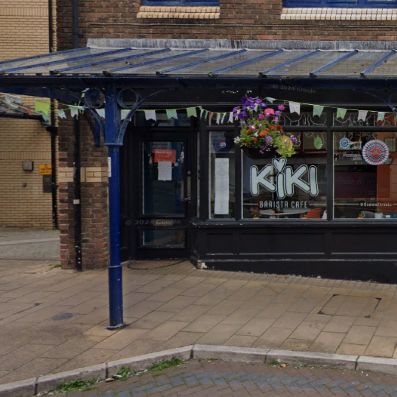 A street view of a Cafe with an awning